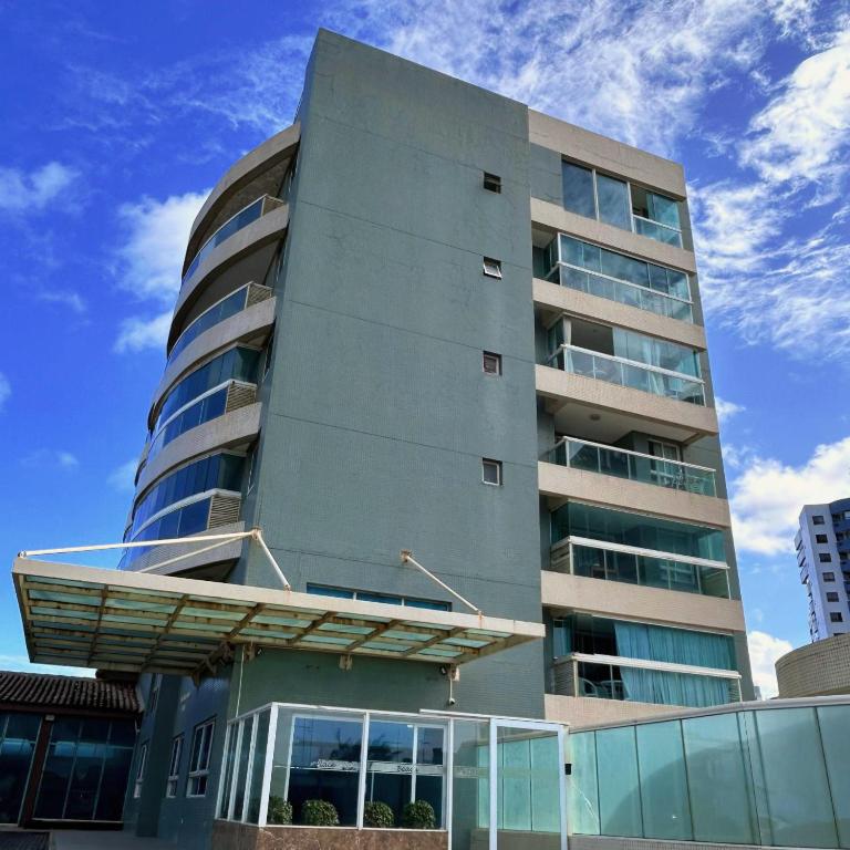 a tall apartment building with a balcony at Anfitrião Guiah! - Beira-mar e ao lado do Centro de Convenções in Salvador