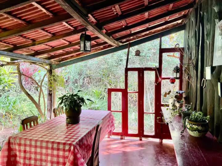 a porch with a table with a red and white table cloth at Cabana Santa Premium in Rio de Janeiro