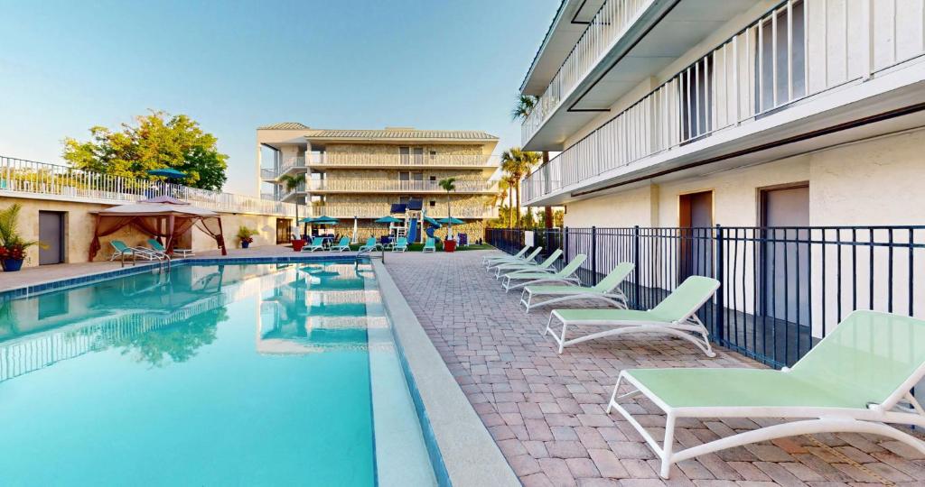 a swimming pool with lounge chairs next to a building at Park Royal Orlando in Kissimmee