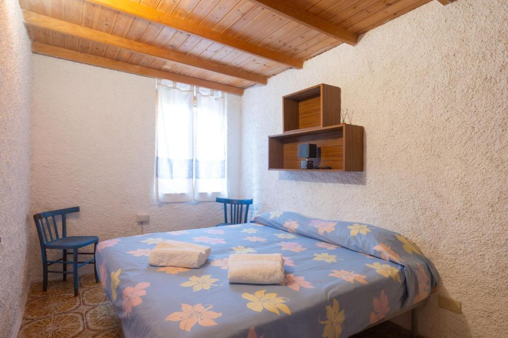Postel nebo postele na pokoji v ubytování Rustico Gallurese