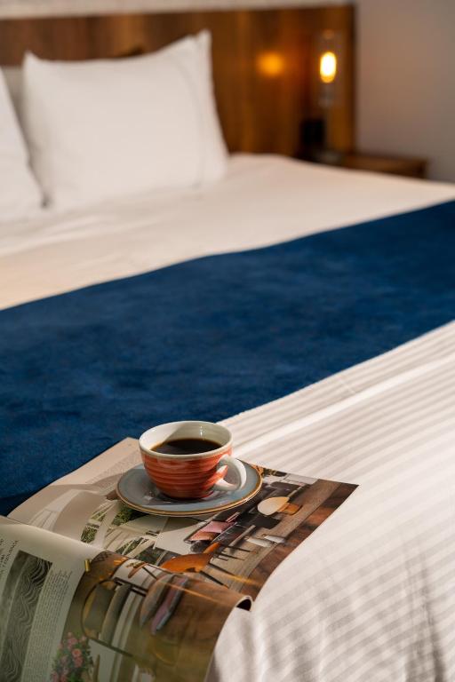Postel nebo postele na pokoji v ubytování Cafe Hotel Medellín