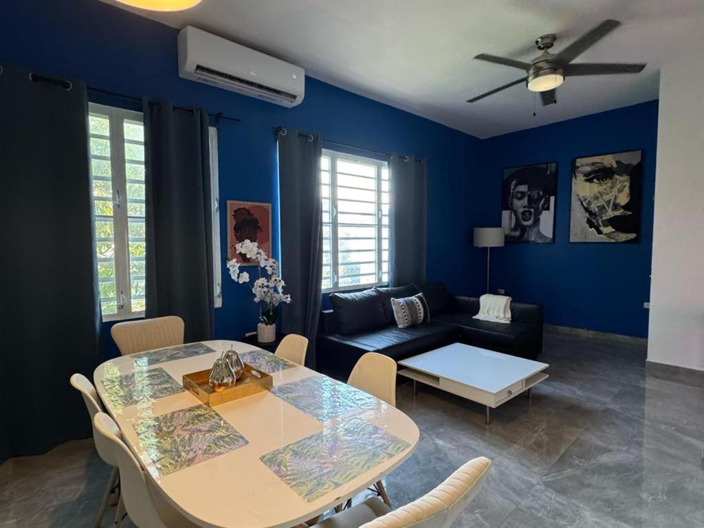 a living room with a table and a couch at Elegant 1-Br Penthouse in Condado! in San Juan