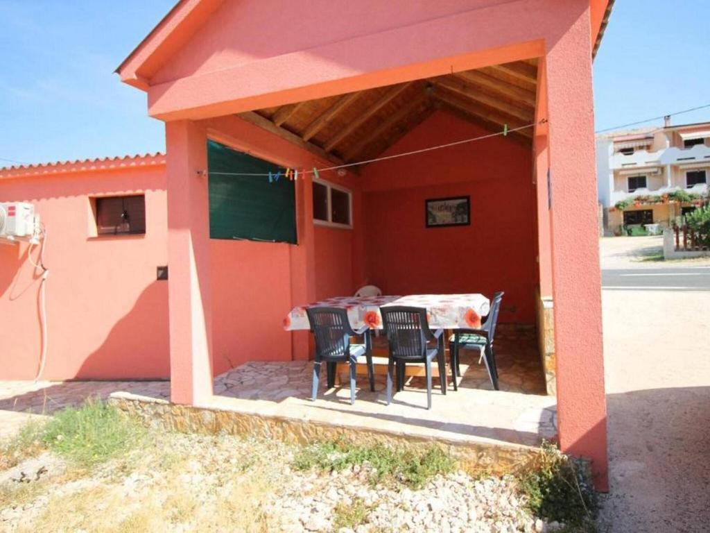 a patio with a table and chairs in a building at Studio in Dinji ka on the Beachfront in Dinjiška