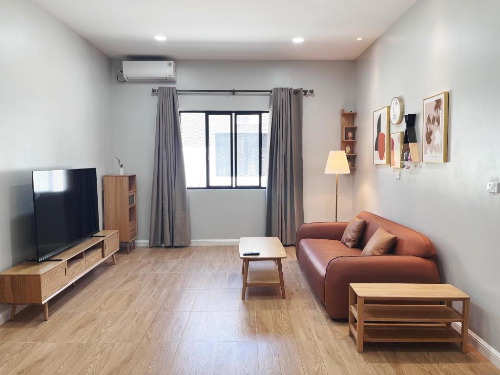a living room with a couch and a television at Nadi Vivi Apartments in Nadi