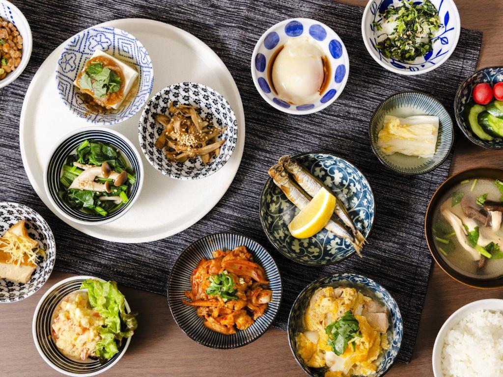 a table with many plates of food on it at Hotel Wing International Tokyo Akabane in Tokyo