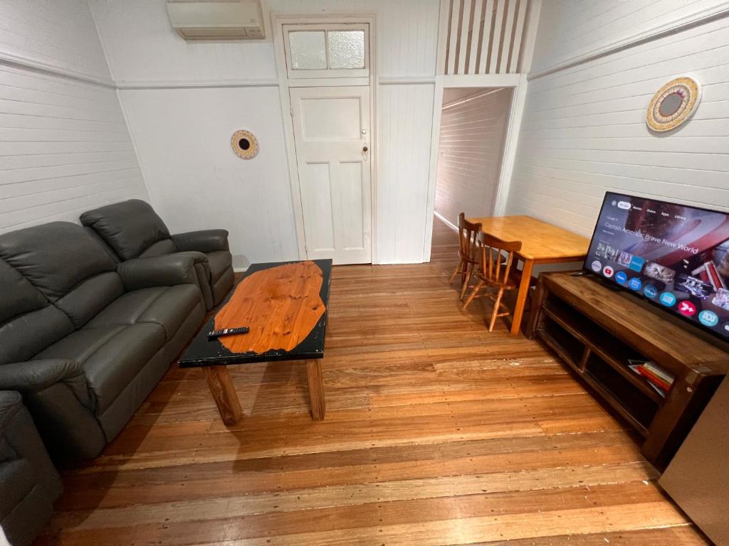 a living room with a couch and a table at Ryan's Rest Boutique Accommodation in Cairns