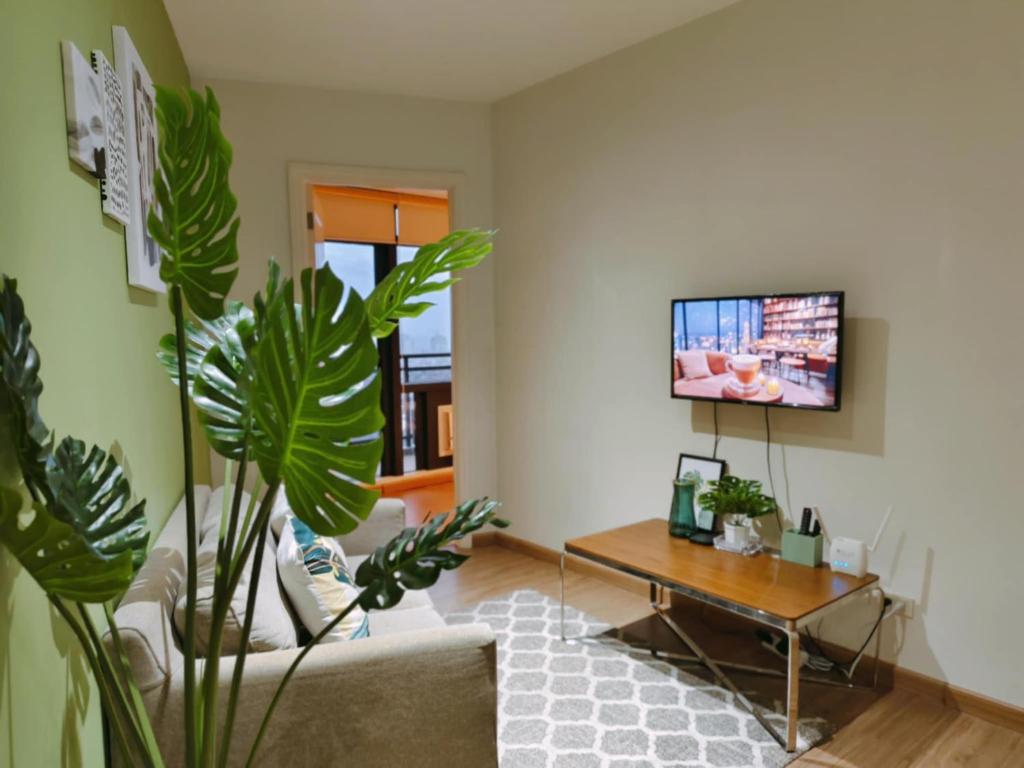 a living room with a couch and a table at Gramercy Residences Makati by Christine Suites PH with Balcony in Manila