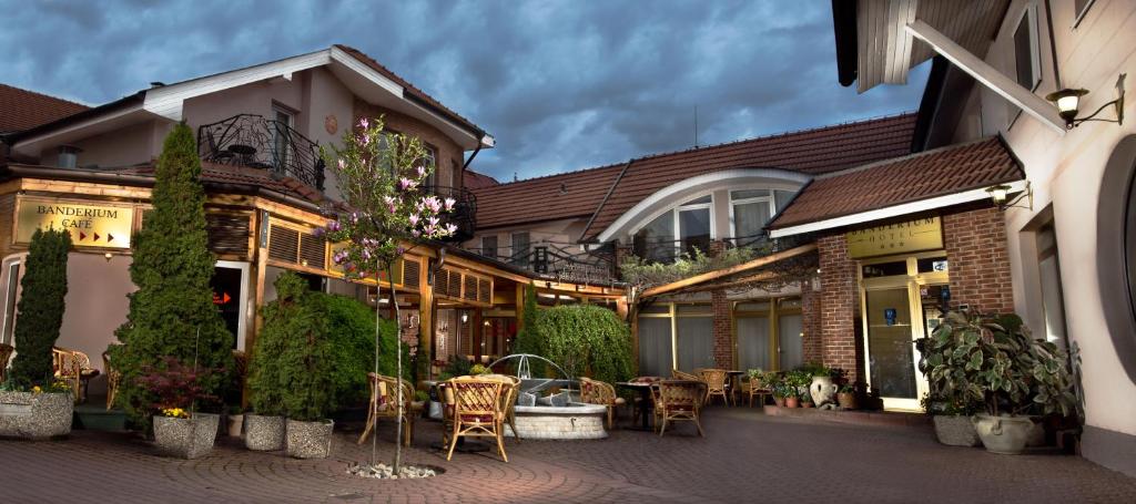 
a living room with a table and chairs in front of a building at Hotel Banderium in Komárno
