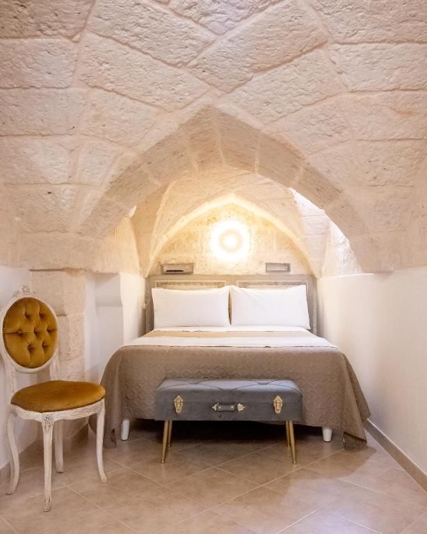 a bedroom with a bed with a stone ceiling at La Stella Del Pupo CATALDO in Fasano