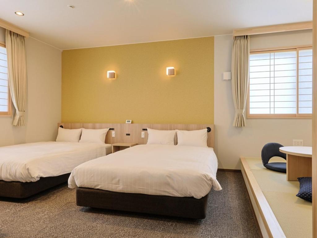 Postel nebo postele na pokoji v ubytování Hotel Kii Tanabe