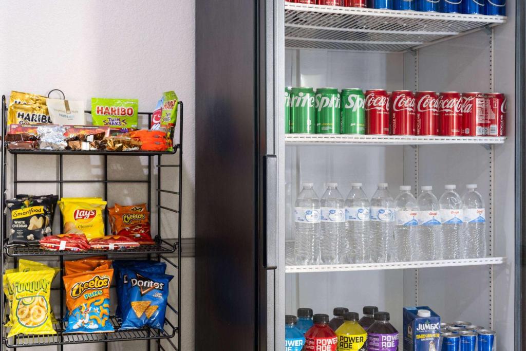 a refrigerator filled with lots of drinks and soda at Days Inn by Wyndham Ardmore in Ardmore