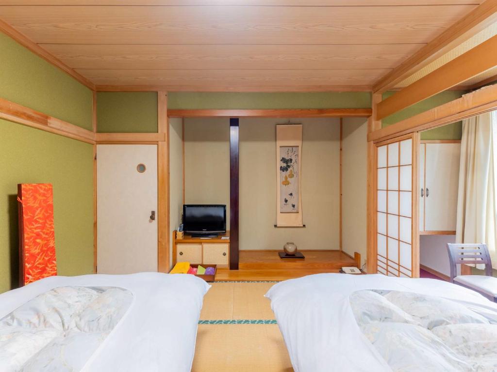 Postel nebo postele na pokoji v ubytování 檜湯の宿　松伯