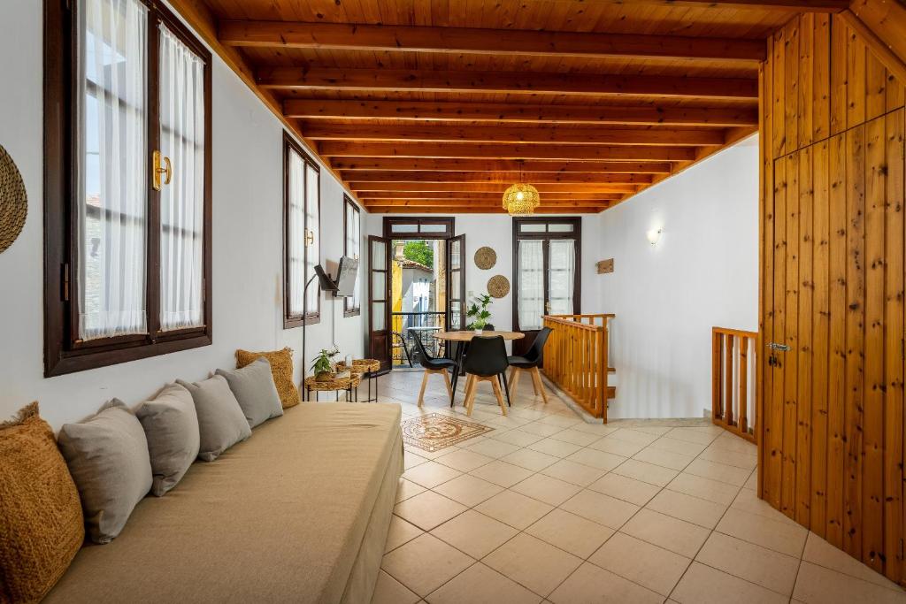a living room with a couch and a table at Ilioni Apartment in Symi