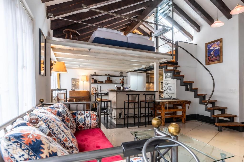a living room with a couch and a loft at alt Hischi Villa Emanuel old Zermatt in Zermatt