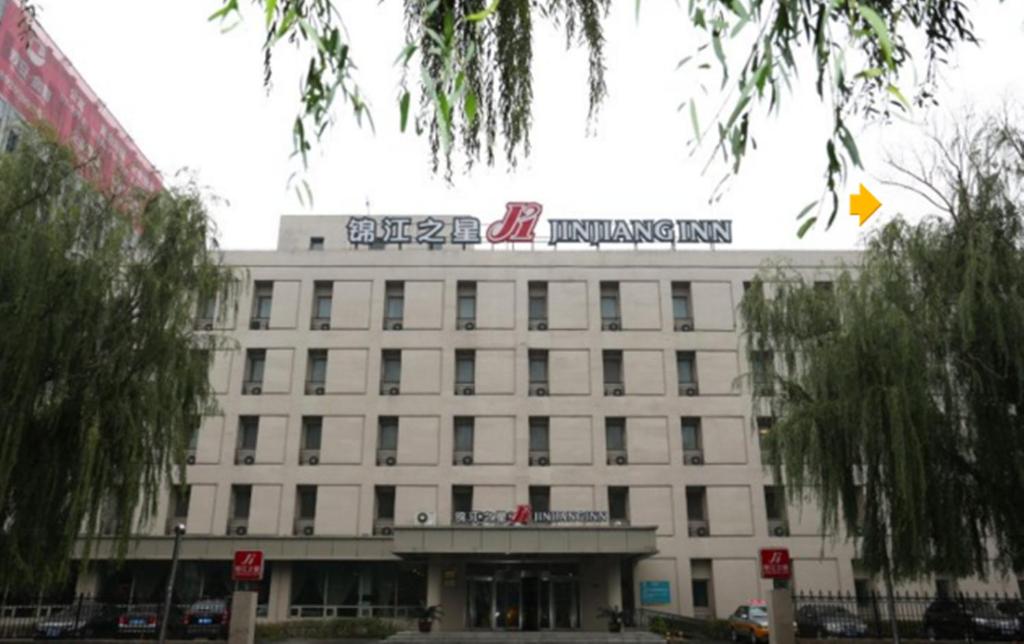 a white building with a sign on top of it at Jinjiang Inn Wuhan Optical Valley Finance Habour in Wuhan