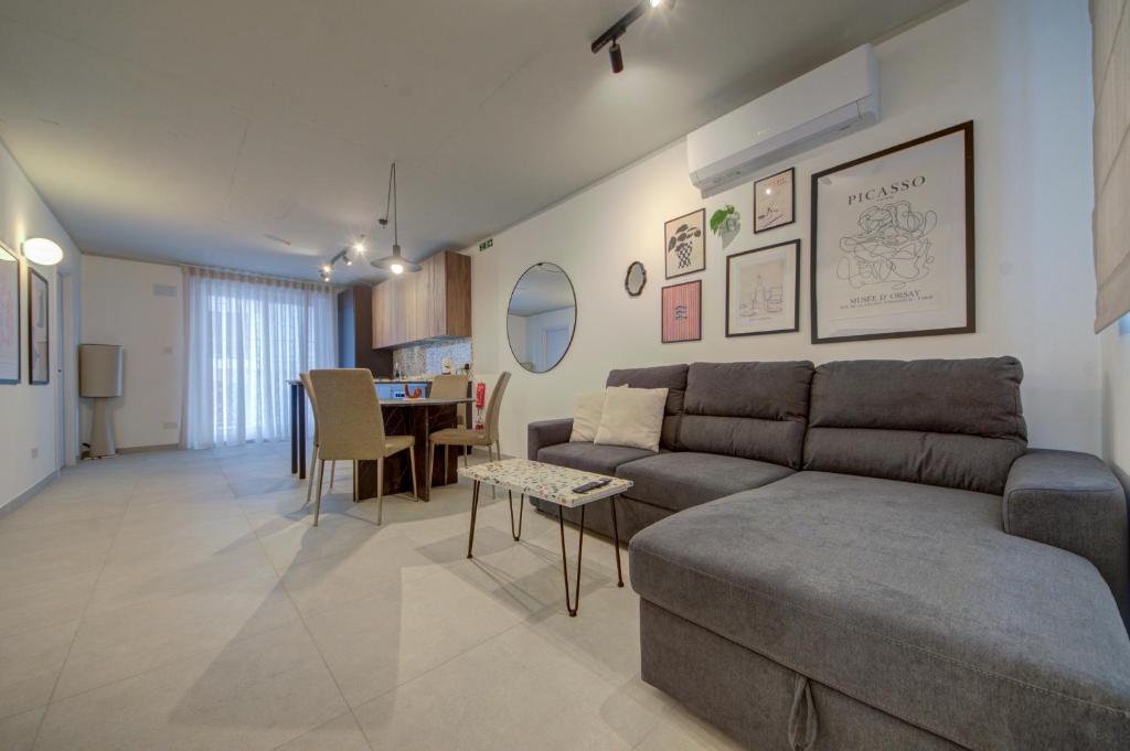 a living room with a couch and a table at Juliet Residence, Apt 4 , Your Home Away from Home in Gzira by SF HOMES in Il-Gżira