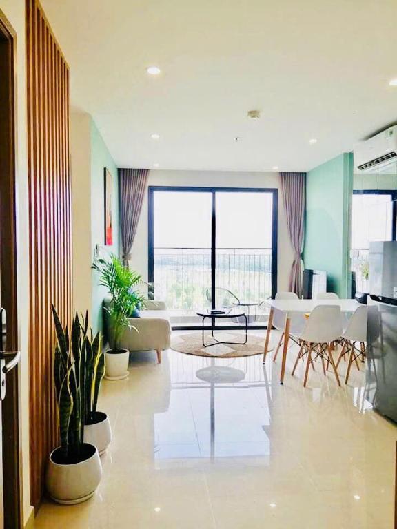 a living room with a table and some plants at LK Homestay S218 in Gia Lâm Pho