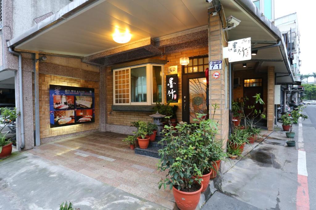 a building with potted plants in front of it at Mozhu Homestay in Hualien City