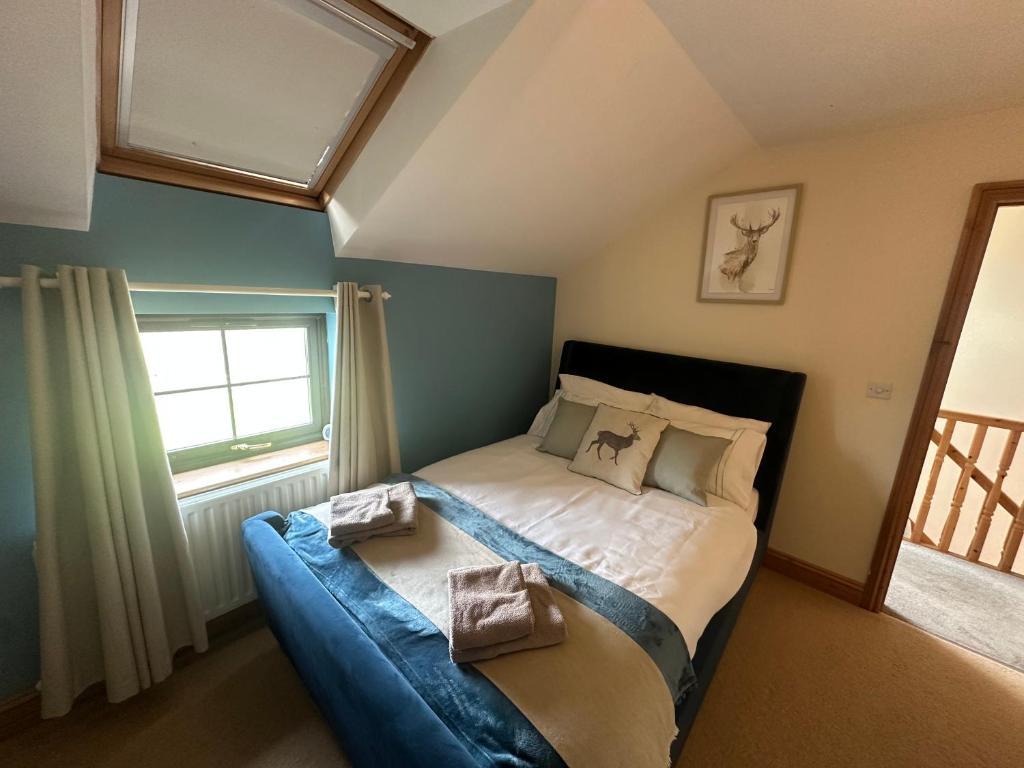 a bedroom with a bed with two pillows on it at The Cottage in Carlisle