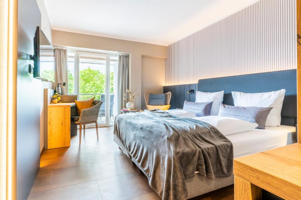Postel nebo postele na pokoji v ubytování Arthotel Bakker