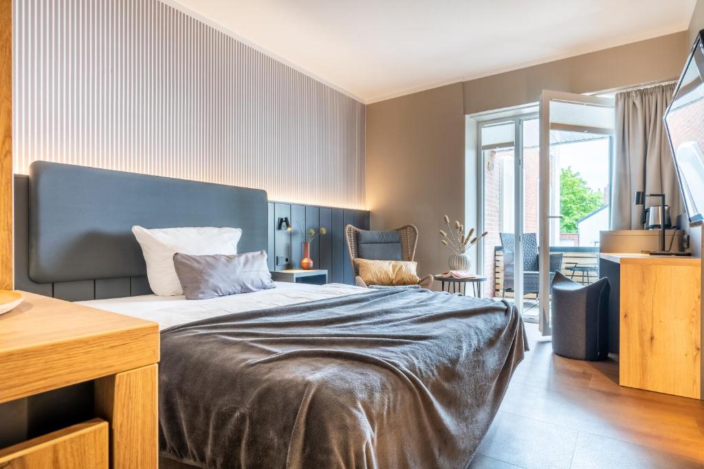 Postel nebo postele na pokoji v ubytování Arthotel Bakker