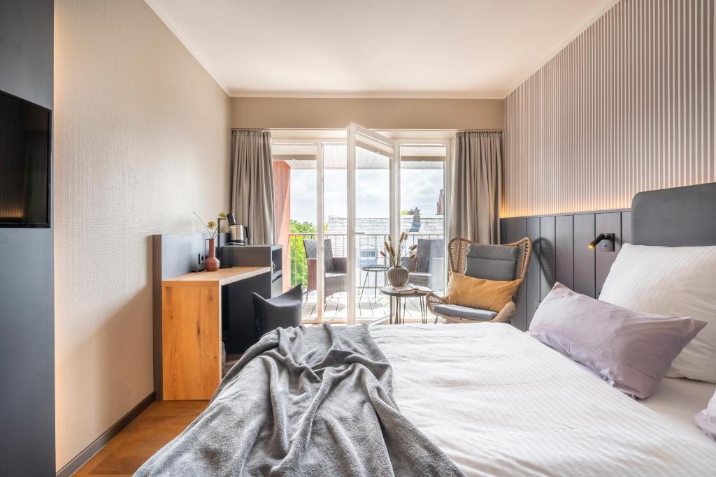 Postel nebo postele na pokoji v ubytování Arthotel Bakker