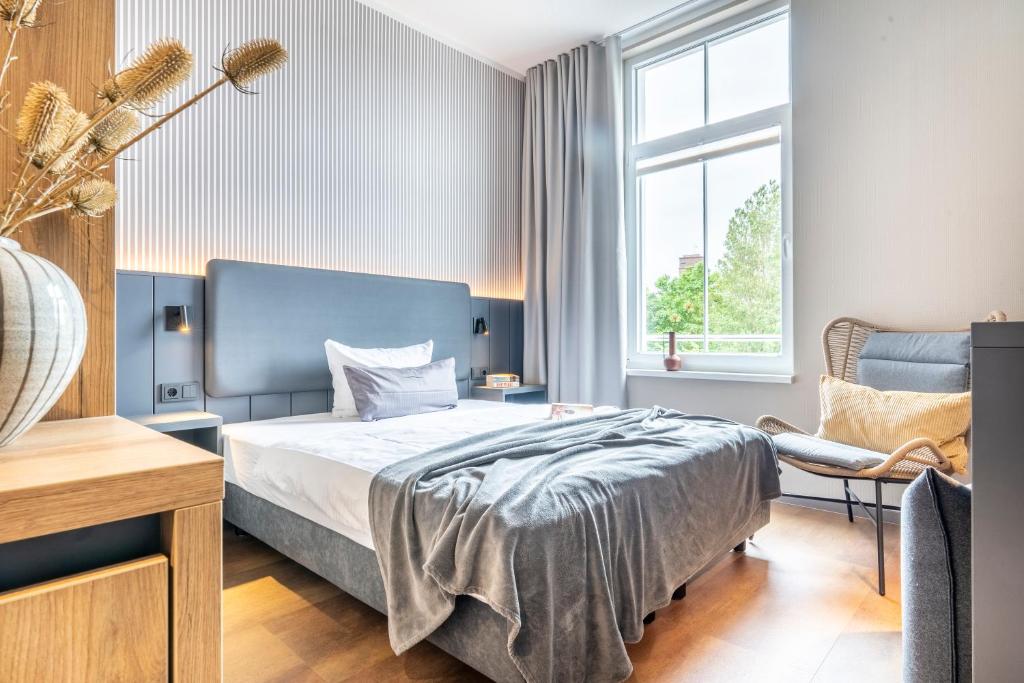 Postel nebo postele na pokoji v ubytování Arthotel Bakker