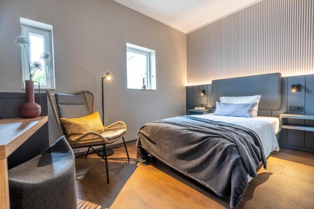 Postel nebo postele na pokoji v ubytování Arthotel Bakker