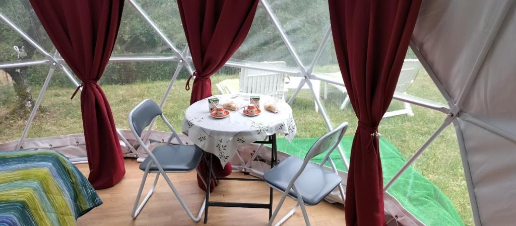 a room with a table and chairs in a yurt at Villa - Malibu' B & B in Lauria