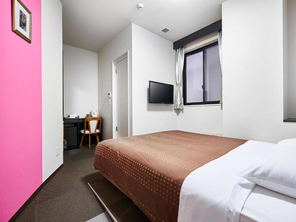 Postel nebo postele na pokoji v ubytování Izutsu Hotel Kyoto Kawaramachi Sanjo