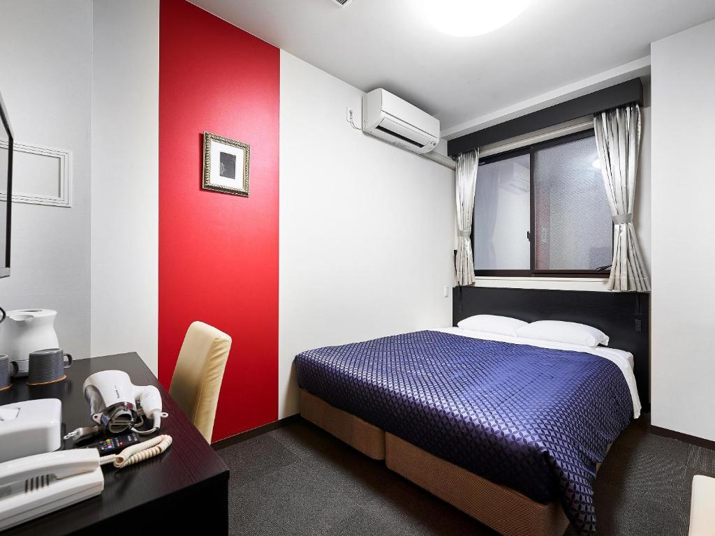 Postel nebo postele na pokoji v ubytování Izutsu Hotel Kyoto Kawaramachi Sanjo