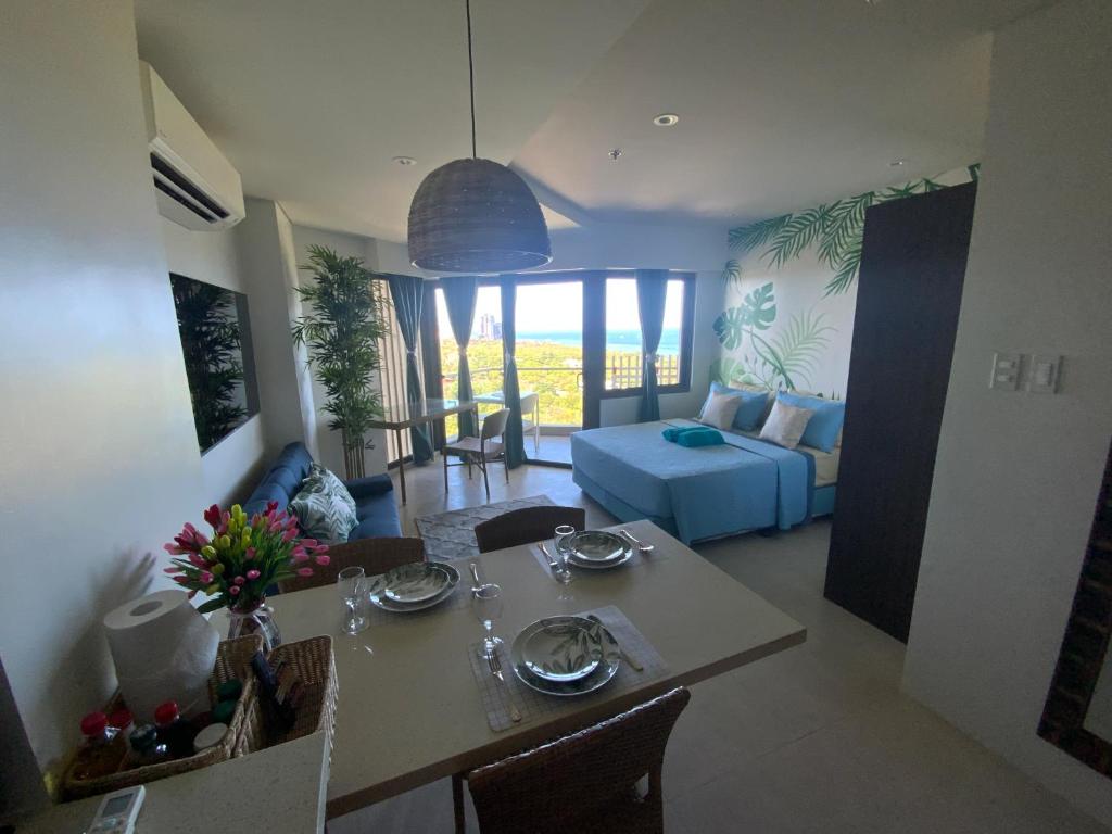 a living room with a table and a couch at Ma Roberta - Tambuli Resort with fast Wifi 16 Floor Studio Type in Lapu Lapu City