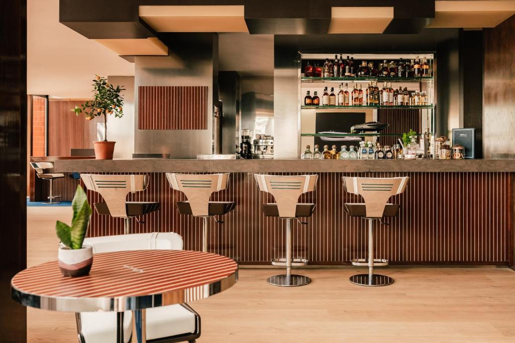 a bar with stools and a table in a room at Hotel de Mar Gran Meliá - Adults Only - The Leading Hotels of the World in Illetas