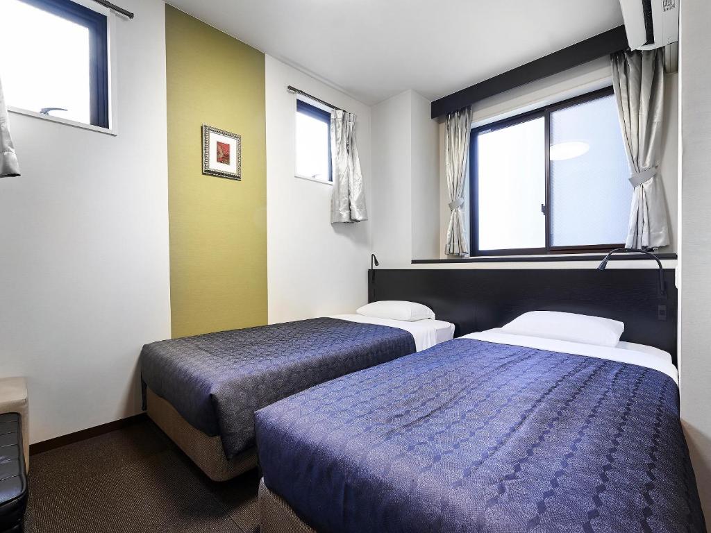 Postel nebo postele na pokoji v ubytování Izutsu Hotel Kyoto Kawaramachi Sanjo
