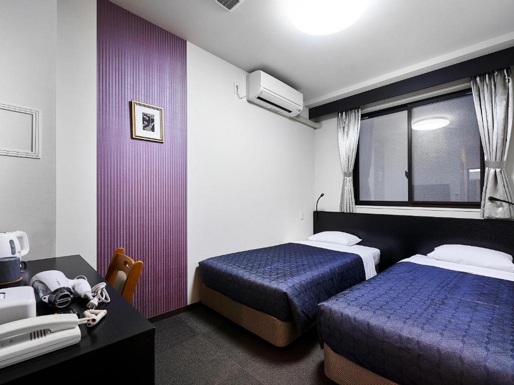 Postel nebo postele na pokoji v ubytování Izutsu Hotel Kyoto Kawaramachi Sanjo
