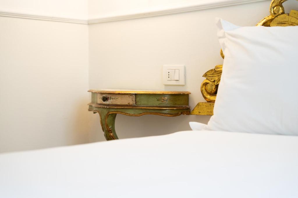 a bedroom with a bed and a table at Residenza Conte di Cavour & Rooftop in Florence