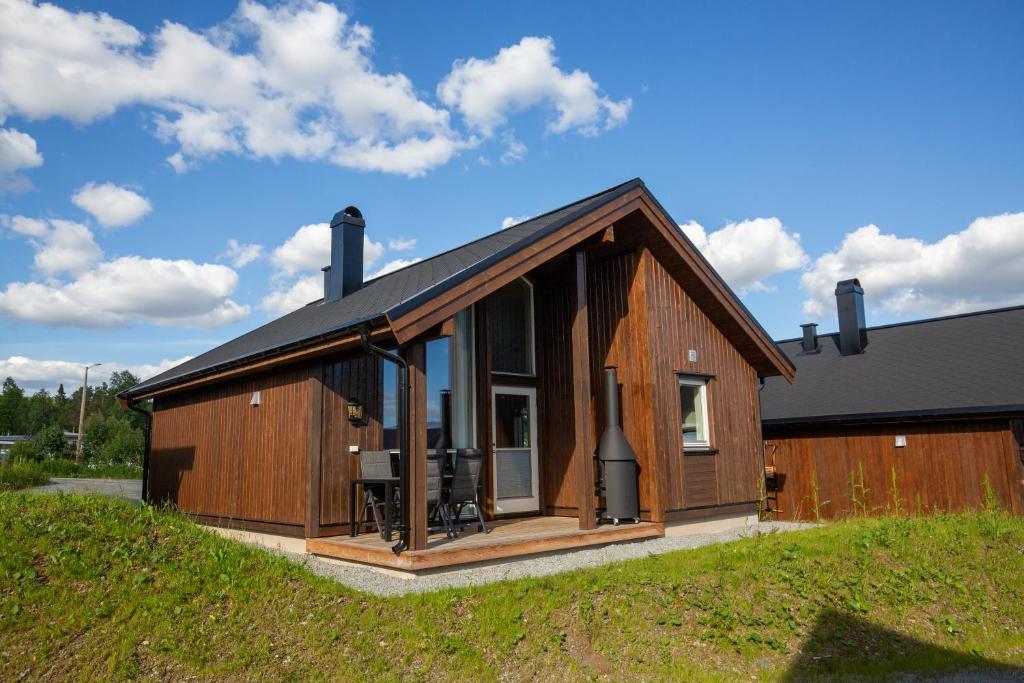 a large wooden house with a large window at Perfect Base For Skiing And Local Events in Beitostøl