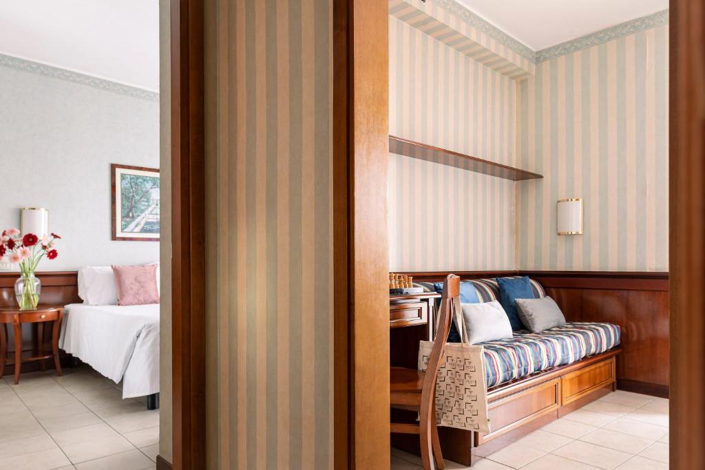 Ένα ή περισσότερα κρεβάτια σε δωμάτιο στο Ripamonti Residence & Hotel Milano