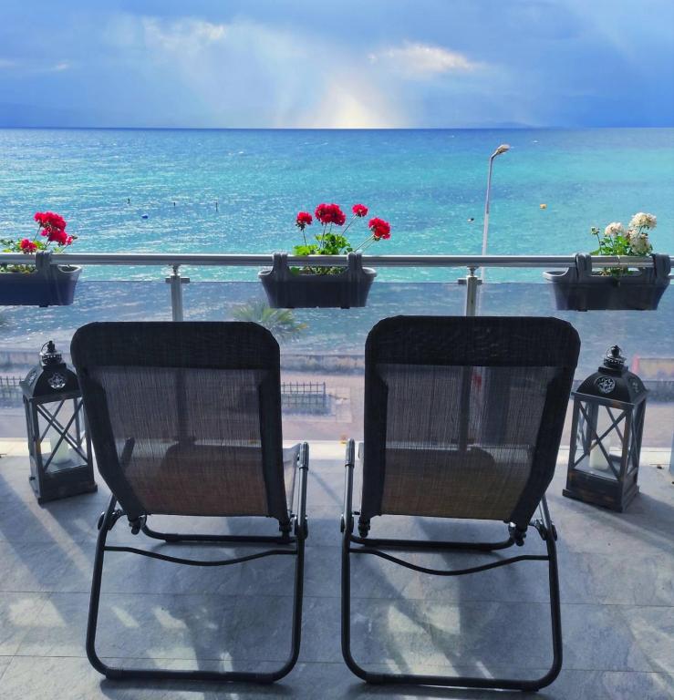 two chairs sitting on a balcony overlooking the ocean at Villa Lena in Ohrid
