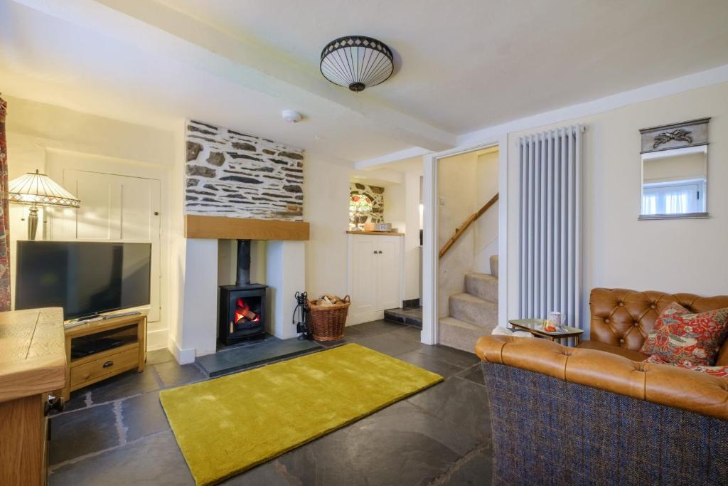 a living room with a couch and a fireplace at Corner House in Ambleside