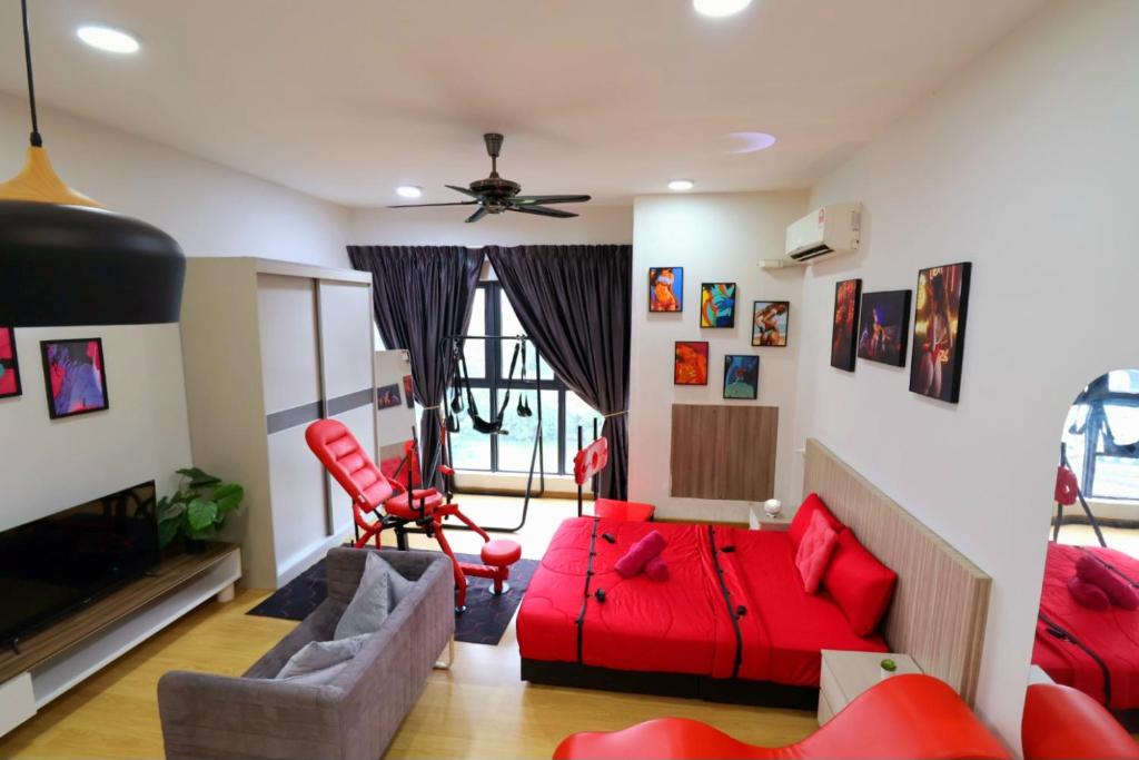 a living room with red furniture and a red couch at Bay Point Love Bed Danga Bay in Johor Bahru