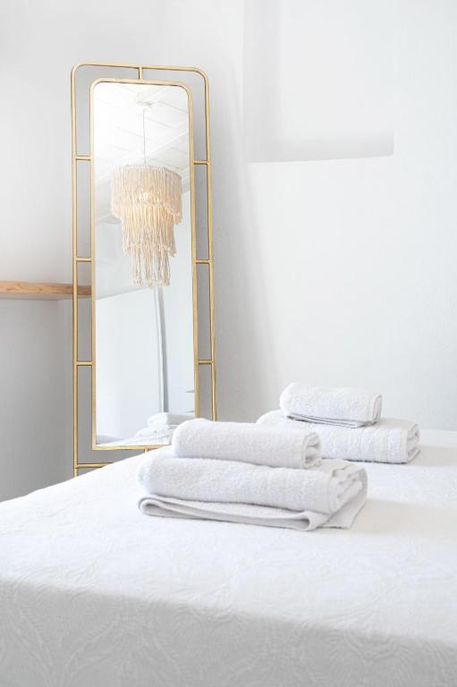 A bed or beds in a room at Amelie Suites Mykonos