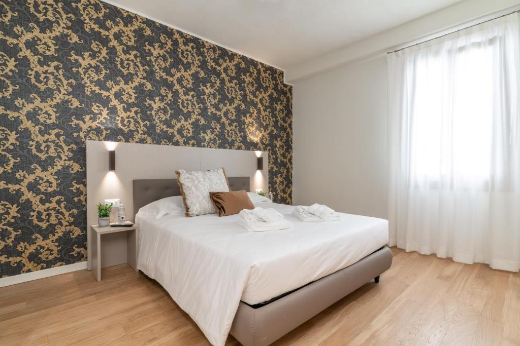 Postel nebo postele na pokoji v ubytování Hotel Grifoni