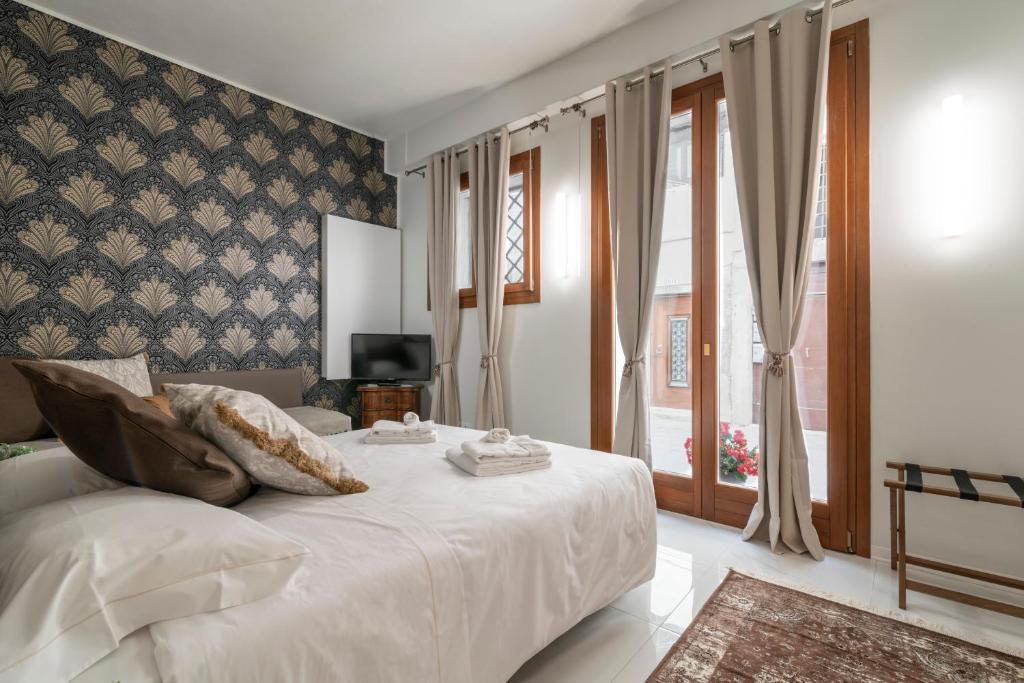 Postel nebo postele na pokoji v ubytování Hotel Grifoni