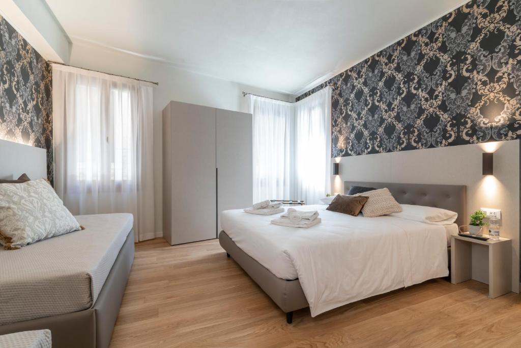 Postel nebo postele na pokoji v ubytování Hotel Grifoni