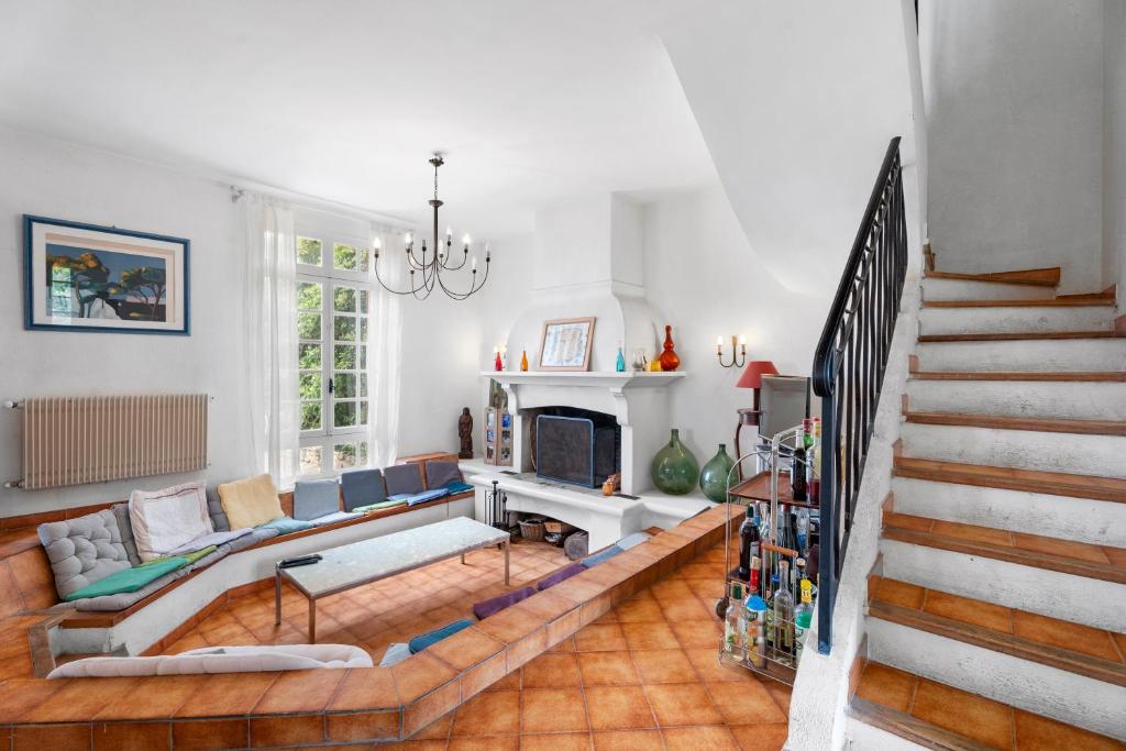 un salon avec un canapé et une cheminée dans l'établissement Villa Les Aloes, à Saint-Cyr-sur-Mer