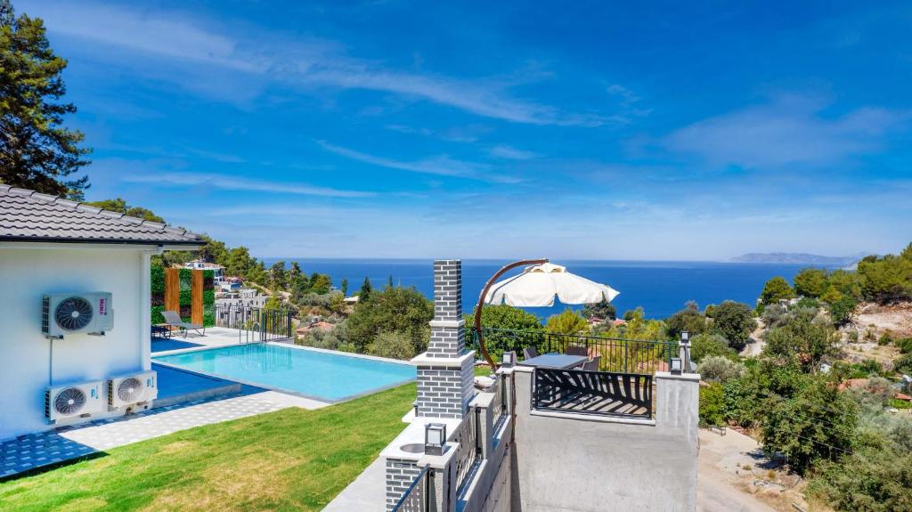 a villa with a swimming pool and a view of the ocean at Villa Zero in Fethiye