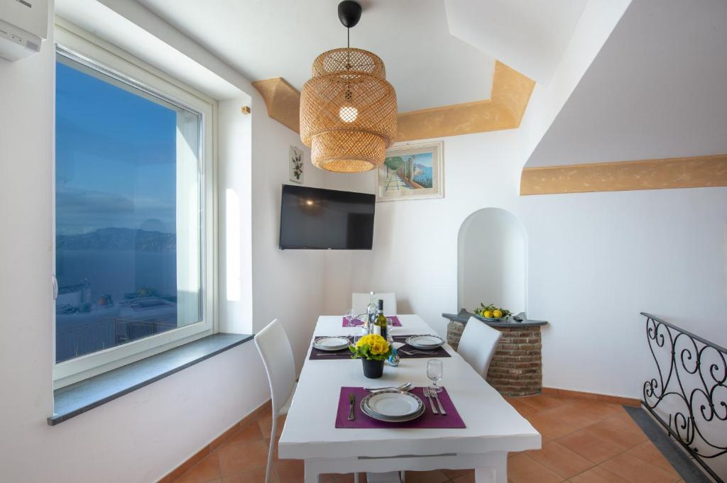 a dining room with a table and a window at Villa Cimino - for walking lovers! in Praiano