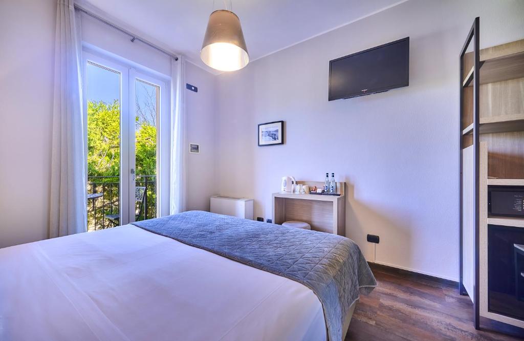 Postel nebo postele na pokoji v ubytování Albergo Silvio