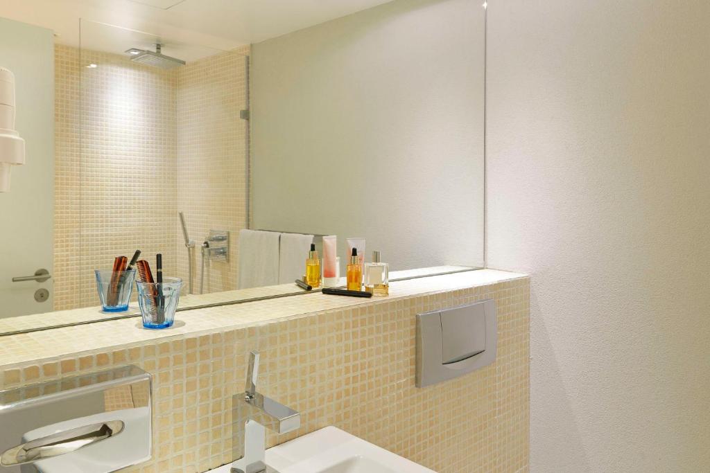 a bathroom with a sink and a mirror at Scandic Front in Copenhagen